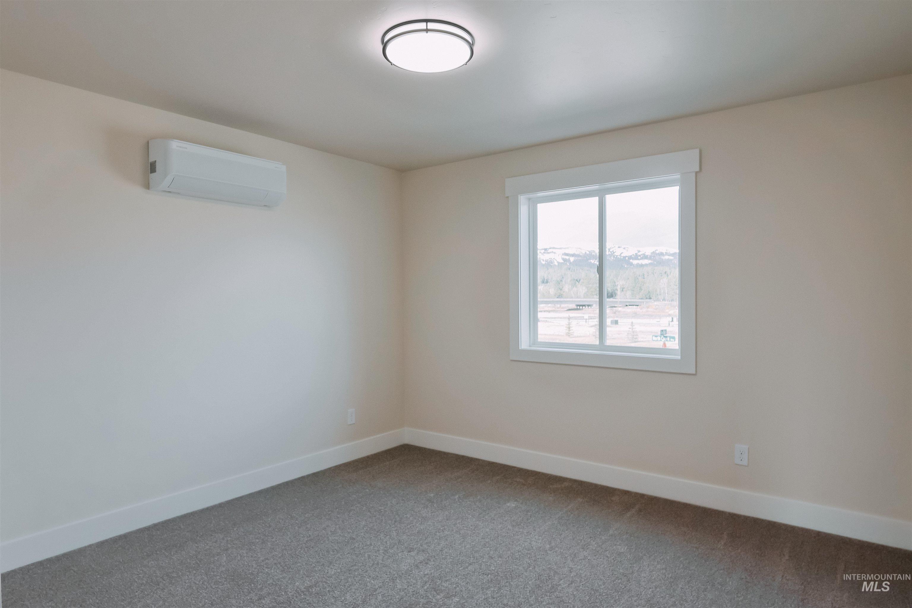 10 North Crk Way Cascade, ID 83611 - Photo 13 of 24 Carpeted spare room with baseboards and a wall mounted mini split