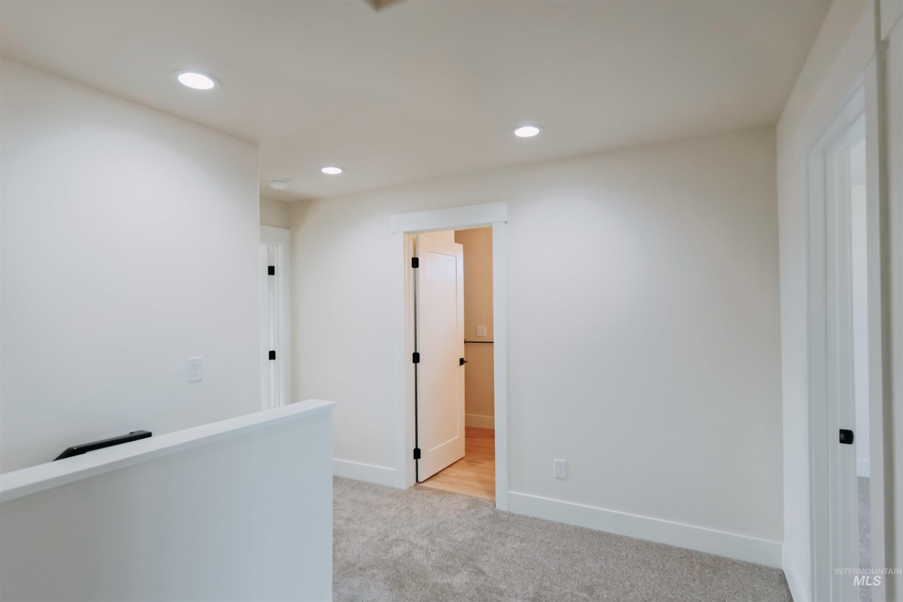10 North Crk Way Cascade, ID 83611 - Photo 14 of 24 Hall with recessed lighting, light carpet, and an upstairs landing