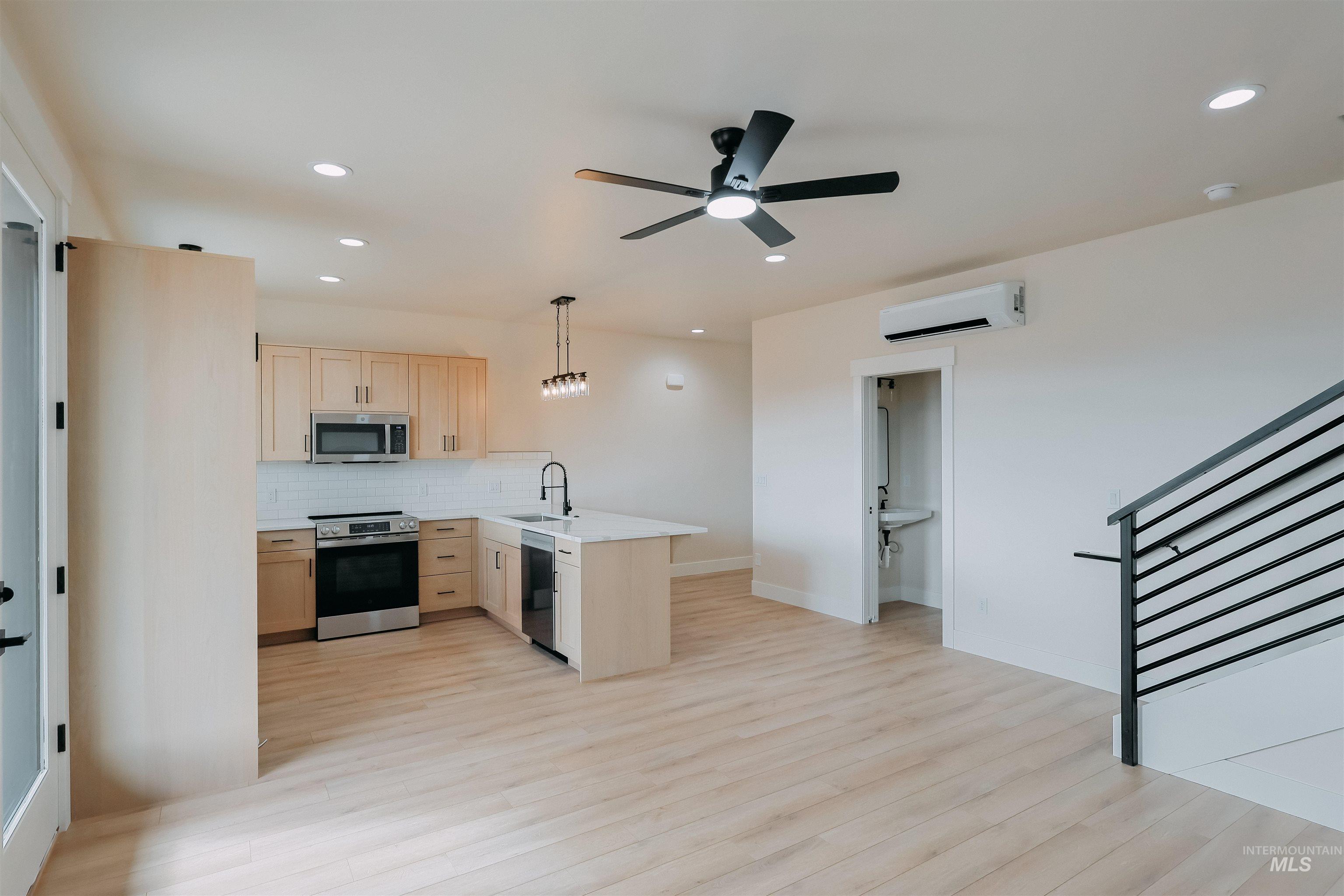 10 North Crk Way Cascade, ID 83611 - Photo 17 of 24 Kitchen featuring light wood finish cabinetry, light countertops, stainless steel appliances, pendant lighting, and a peninsula