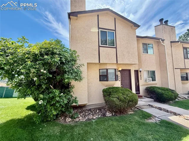 a view of a front of a house with a yard