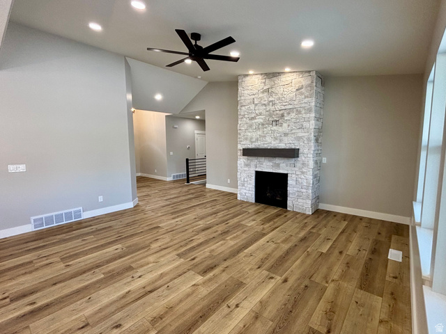 1184 West 3250 North Ogden, UT 84414 - Photo 16 of 69 Living space featuring a stacked stone fireplace with a dark wood mantel and a black fireplace