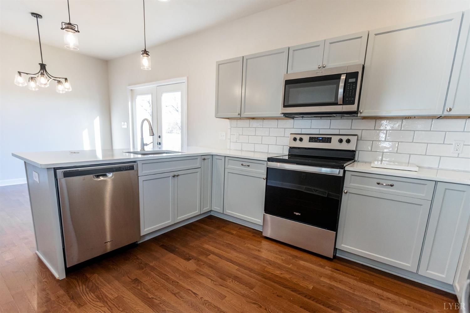 245 Country Estates Road Appomattox, VA 24522 - Photo 17 of 41 a kitchen with a sink cabinets and wooden floor