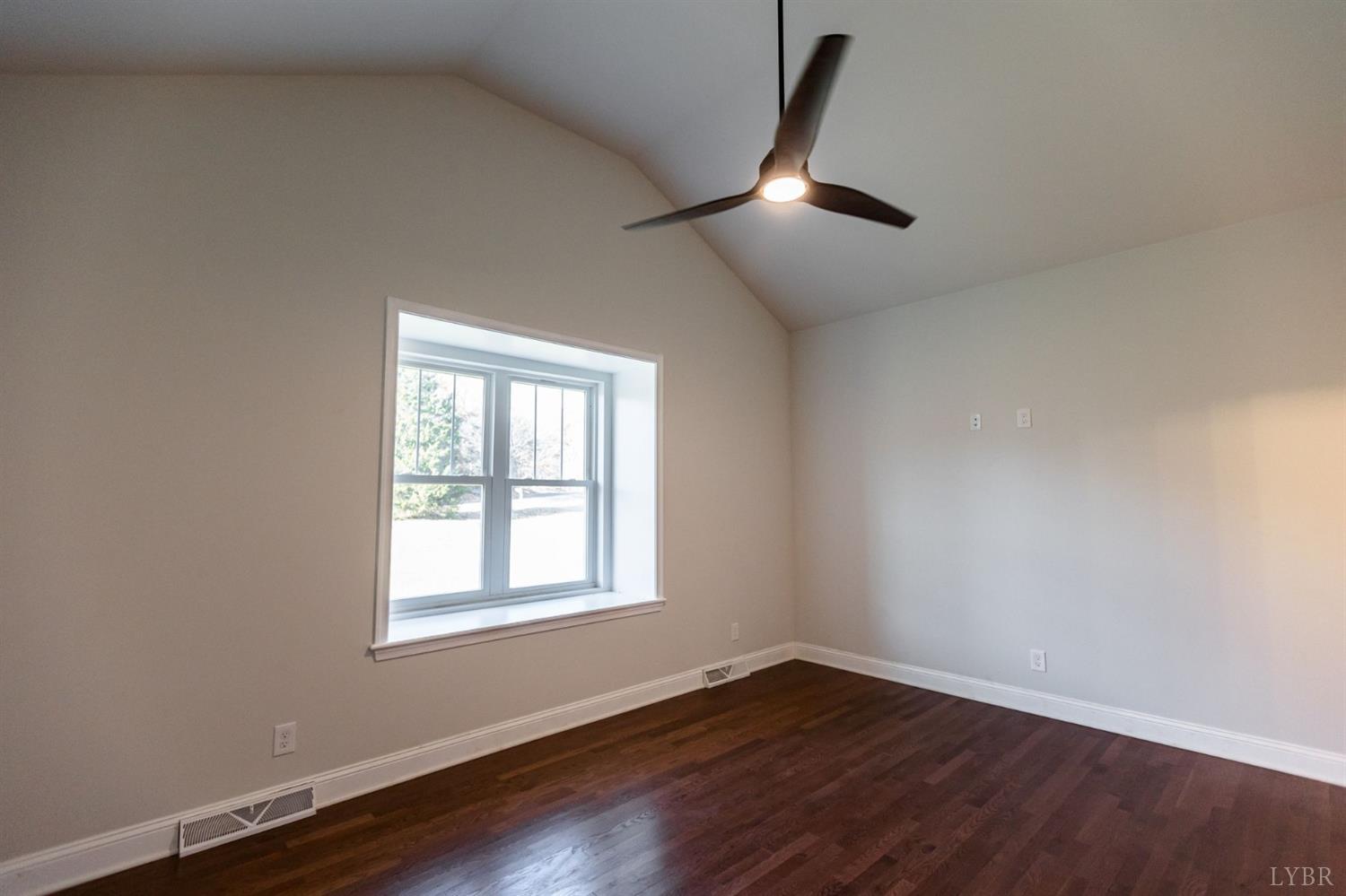 245 Country Estates Road Appomattox, VA 24522 - Photo 20 of 41 an empty room with wooden floor fan and windows