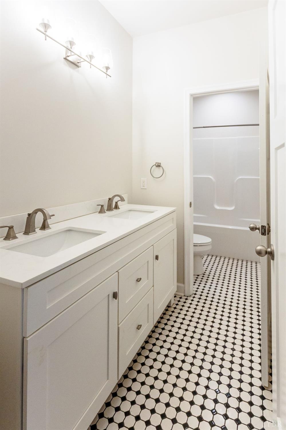 245 Country Estates Road Appomattox, VA 24522 - Photo 24 of 41 a bathroom with a sink a toilet and a mirror