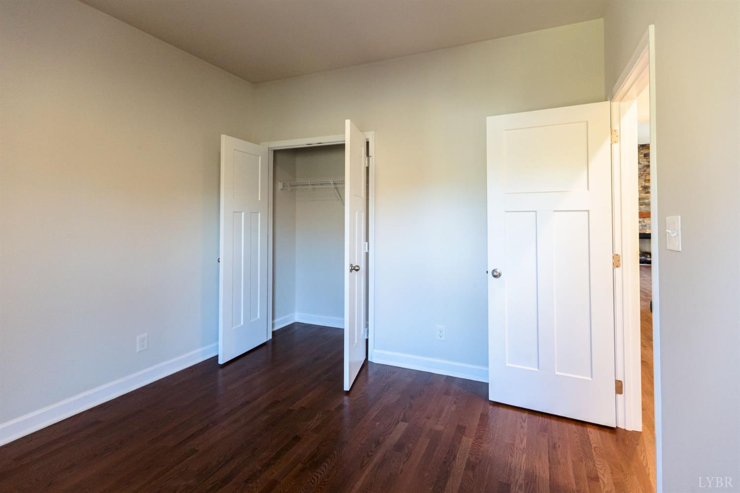 245 Country Estates Road Appomattox, VA 24522 - Photo 27 of 41 an empty room with wooden floor & closet area