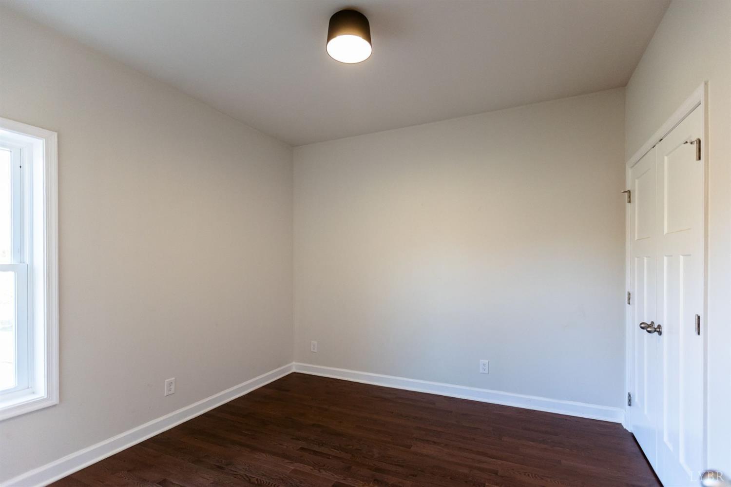 245 Country Estates Road Appomattox, VA 24522 - Photo 30 of 41 an empty room with wooden floor and windows