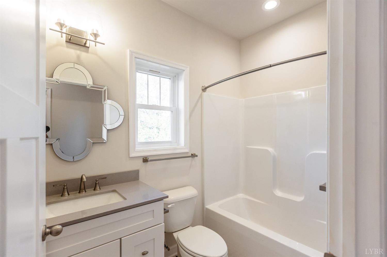 245 Country Estates Road Appomattox, VA 24522 - Photo 32 of 41 a bathroom with a granite countertop sink toilet and shower
