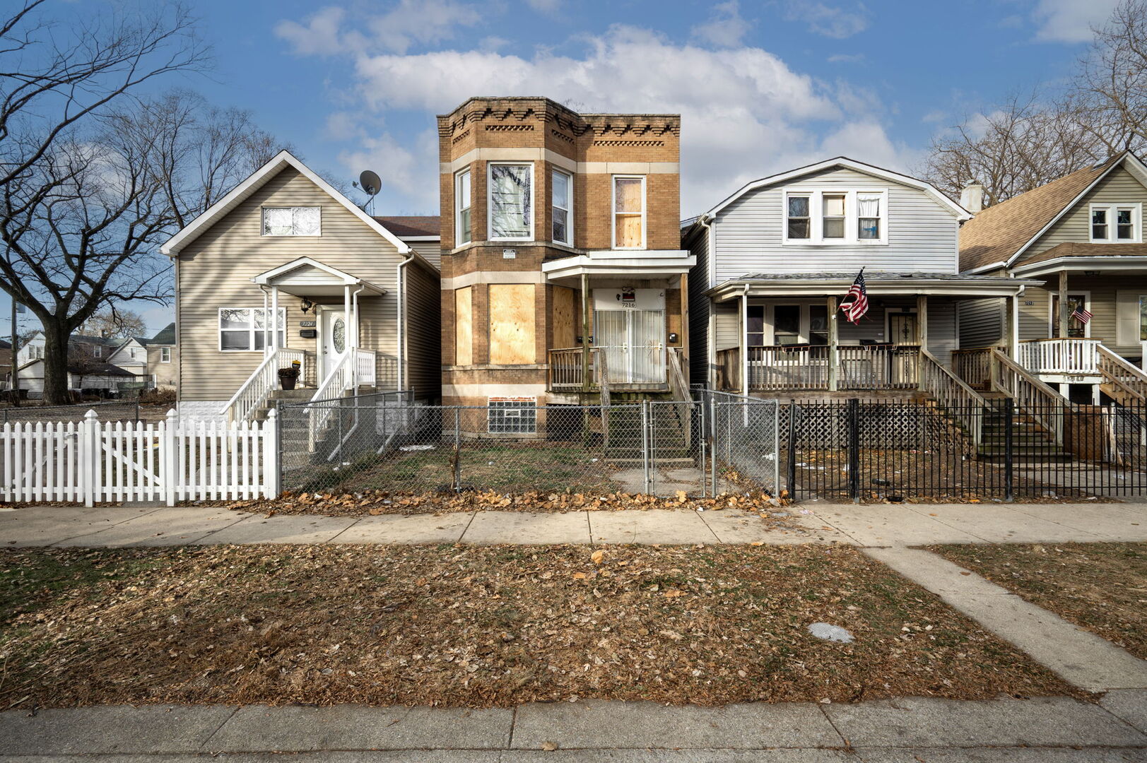 7216 South Green Street Chicago, IL 60621 - Photo 15 of 19 a front view of a residential apartment building with a yard