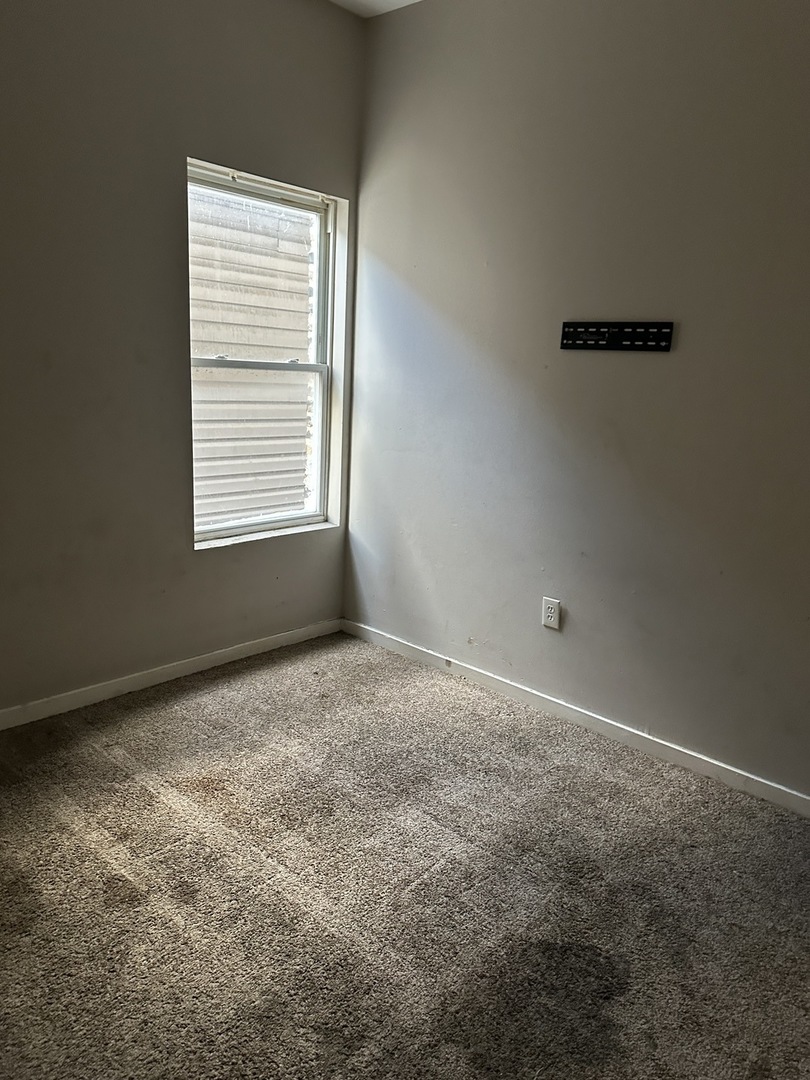 7216 South Green Street Chicago, IL 60621 - Photo 3 of 19 a view of an empty room with a window