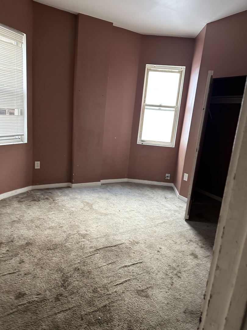 7216 South Green Street Chicago, IL 60621 - Photo 5 of 19 an empty room with windows