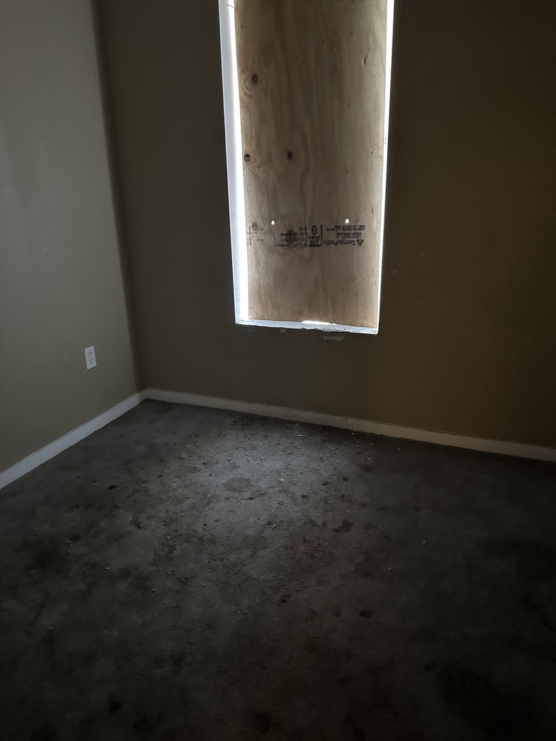 7216 South Green Street Chicago, IL 60621 - Photo 7 of 19 an empty room with a window