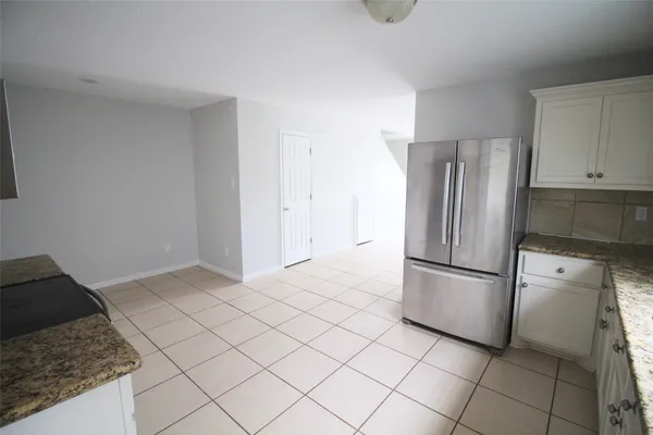 a kitchen with a sink a stove and cabinets