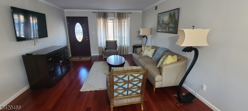 5 Tower Road Livingston, NJ 07039 - Photo 2 of 7 a living room with furniture and a mirror