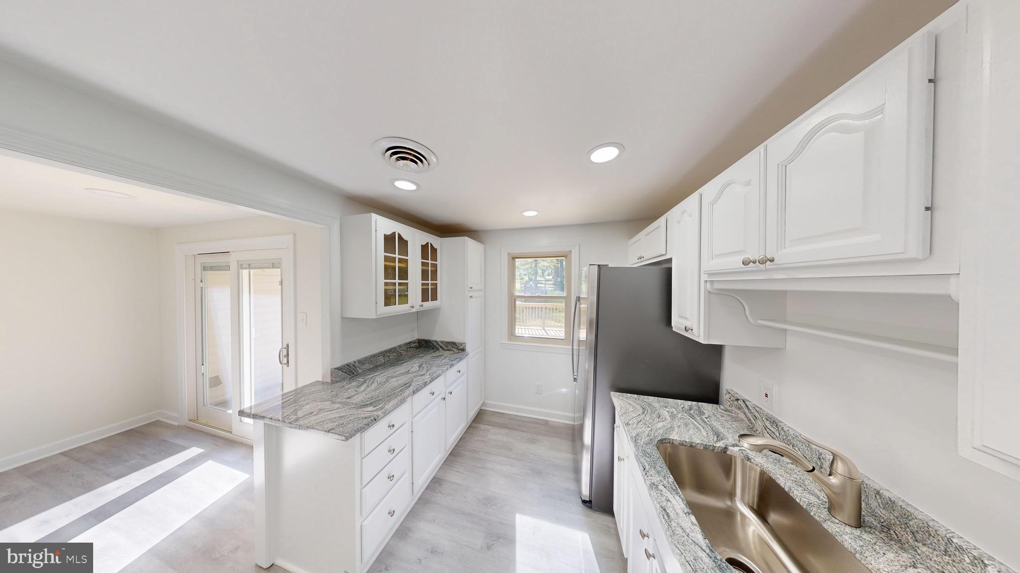 729 West Watersville Road Mount Airy, MD 21771 - Photo 8 of 42 a large white kitchen with granite countertop a sink