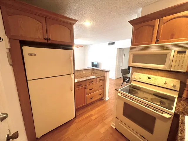 a kitchen with appliances and cabinets