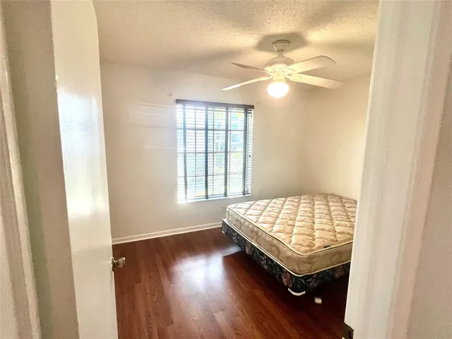 a room with wooden floor and window