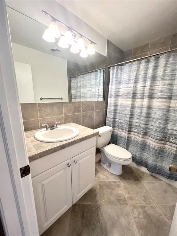 6600 Northeast 22nd Way, Unit 2332 Fort Lauderdale, FL 33308 - Photo 10 of 29 a bathroom with a sink toilet and shower