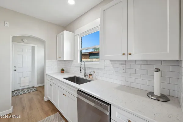 a kitchen with stainless steel appliances a stove microwave and refrigerator