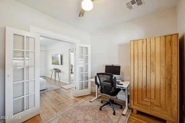 a view of a workspace with furniture and a window