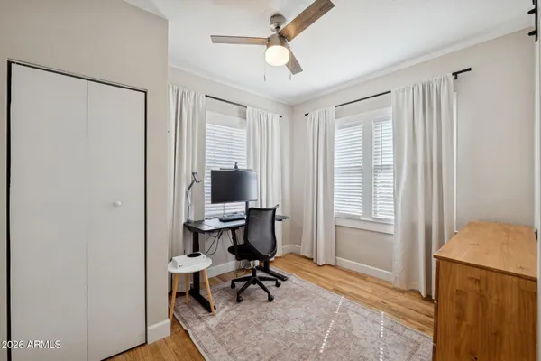 a view of a workspace with furniture and a window