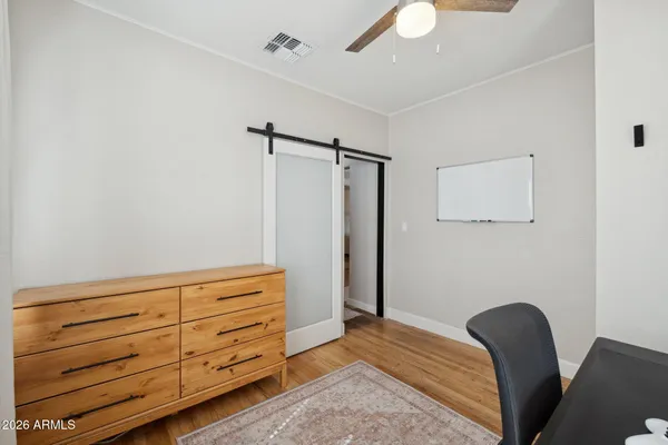 a bedroom with a bed and a dresser