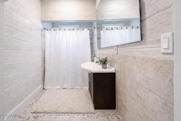 a bathroom with a sink and mirror