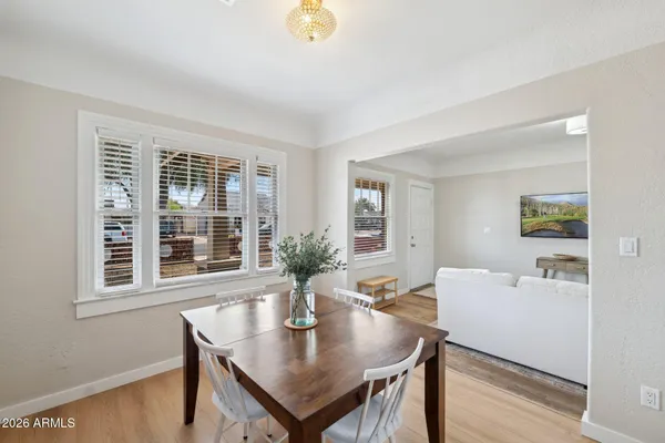 a view of a dining room with furniture and wooden floor