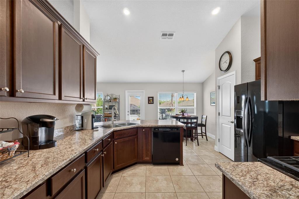 2429 Twin Lake View Road Winter Haven, FL 33881 - Photo 10 of 37 a kitchen with stainless steel appliances granite countertop a sink counter space and stainless steel appliances