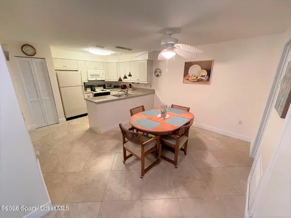 a kitchen with a table and chairs in it