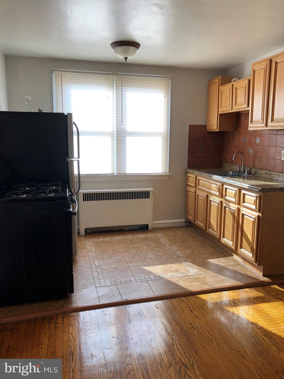 7558 Mayland Street, Unit 2 Philadelphia, PA 19138 - Photo 2 of 8 a kitchen with stainless steel appliances granite countertop a stove a sink and a microwave