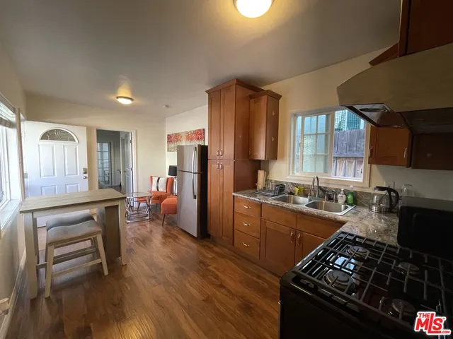 a kitchen with stainless steel appliances granite countertop a stove refrigerator and a stove