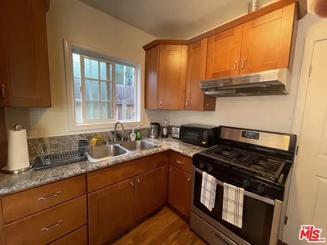 a kitchen with stainless steel appliances granite countertop a stove sink and cabinets
