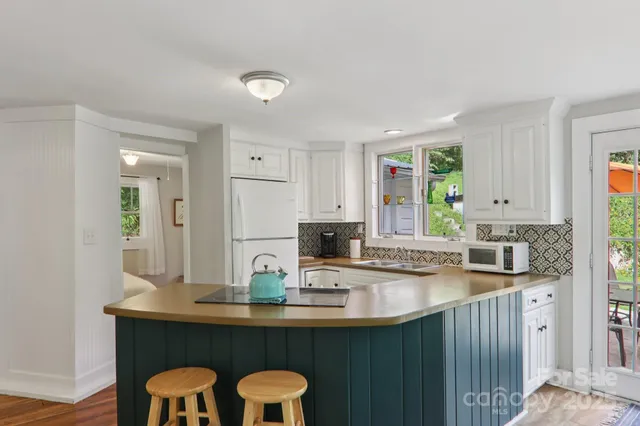 a kitchen with granite countertop a sink and cabinets