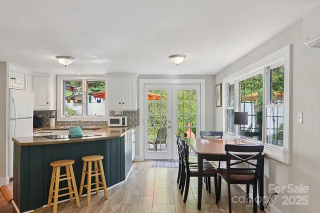 a dining room with furniture and wooden floor