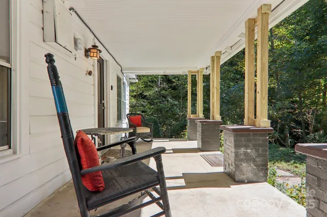 a living room with furniture and large windows