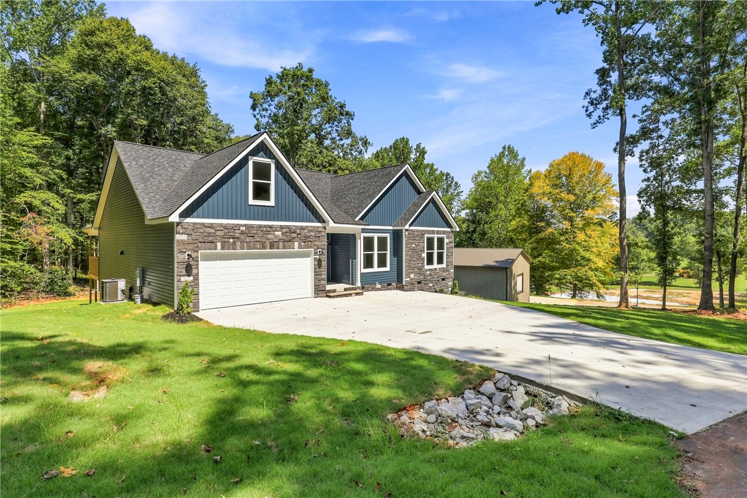 216 West Halfway Branch Road Walhalla, SC 29691 - Photo 31 of 41 An inviting stone and siding exterior rises above a spacious concrete driveway.