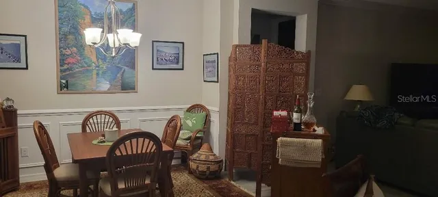 a view of a dining room with furniture and chandelier