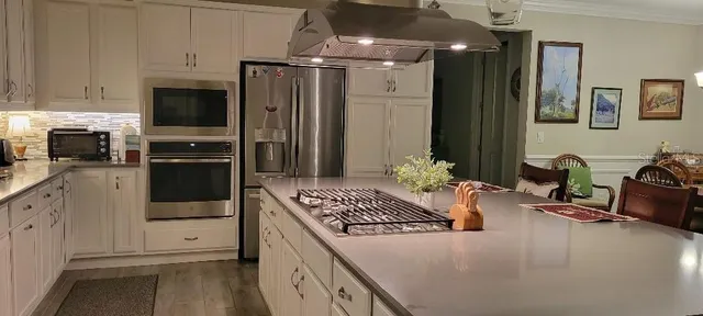 a kitchen with a refrigerator and a sink