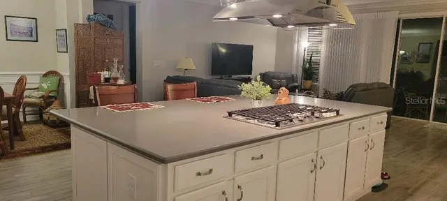 a large kitchen with a table chairs and refrigerator
