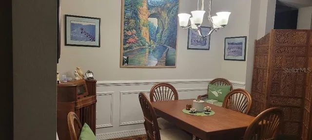 a dining room with furniture and chandelier