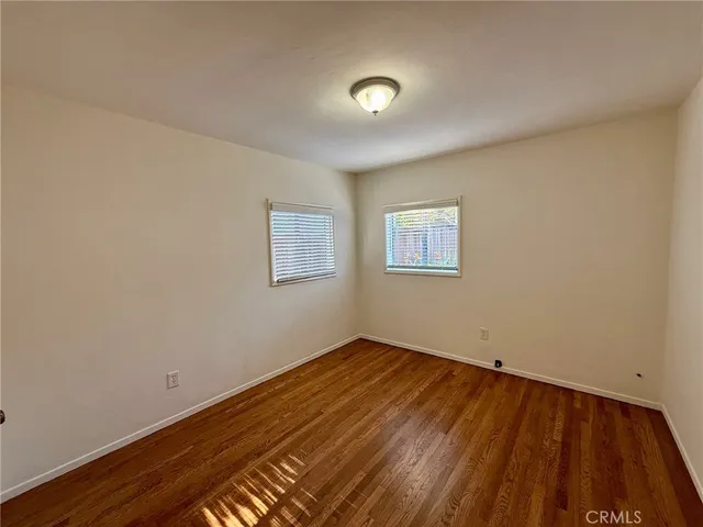 a view of a room with wooden floor and white walls