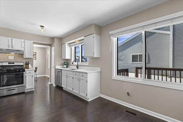 a kitchen with stainless steel appliances granite countertop a stove and a sink