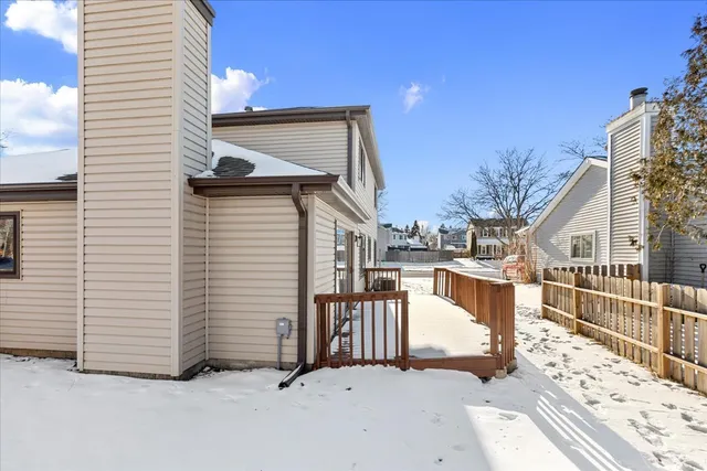 a view of a house with a wooden fence