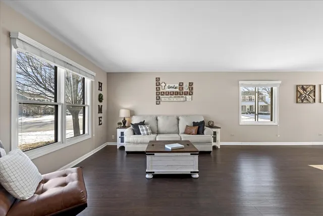 a living room with furniture and floor to ceiling windows