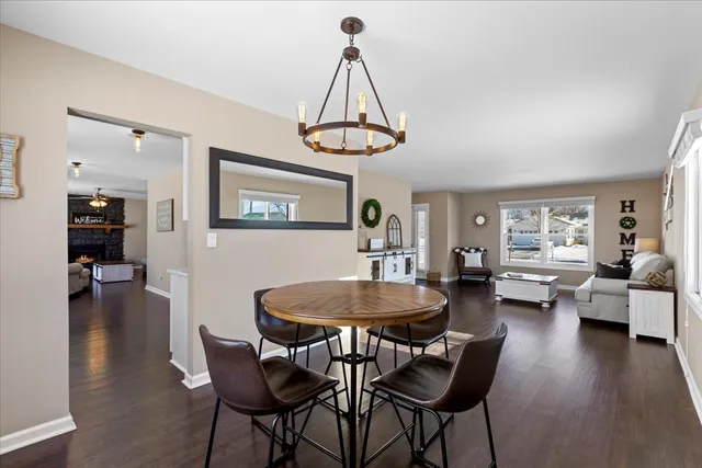 a dining room with furniture window and wooden floor
