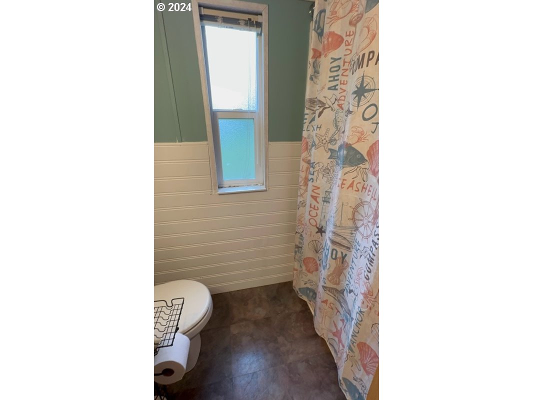28800 Salmon River Highway Grand Ronde, OR 97347 - Photo 24 of 37 a bathroom with a toilet and a shower curtain
