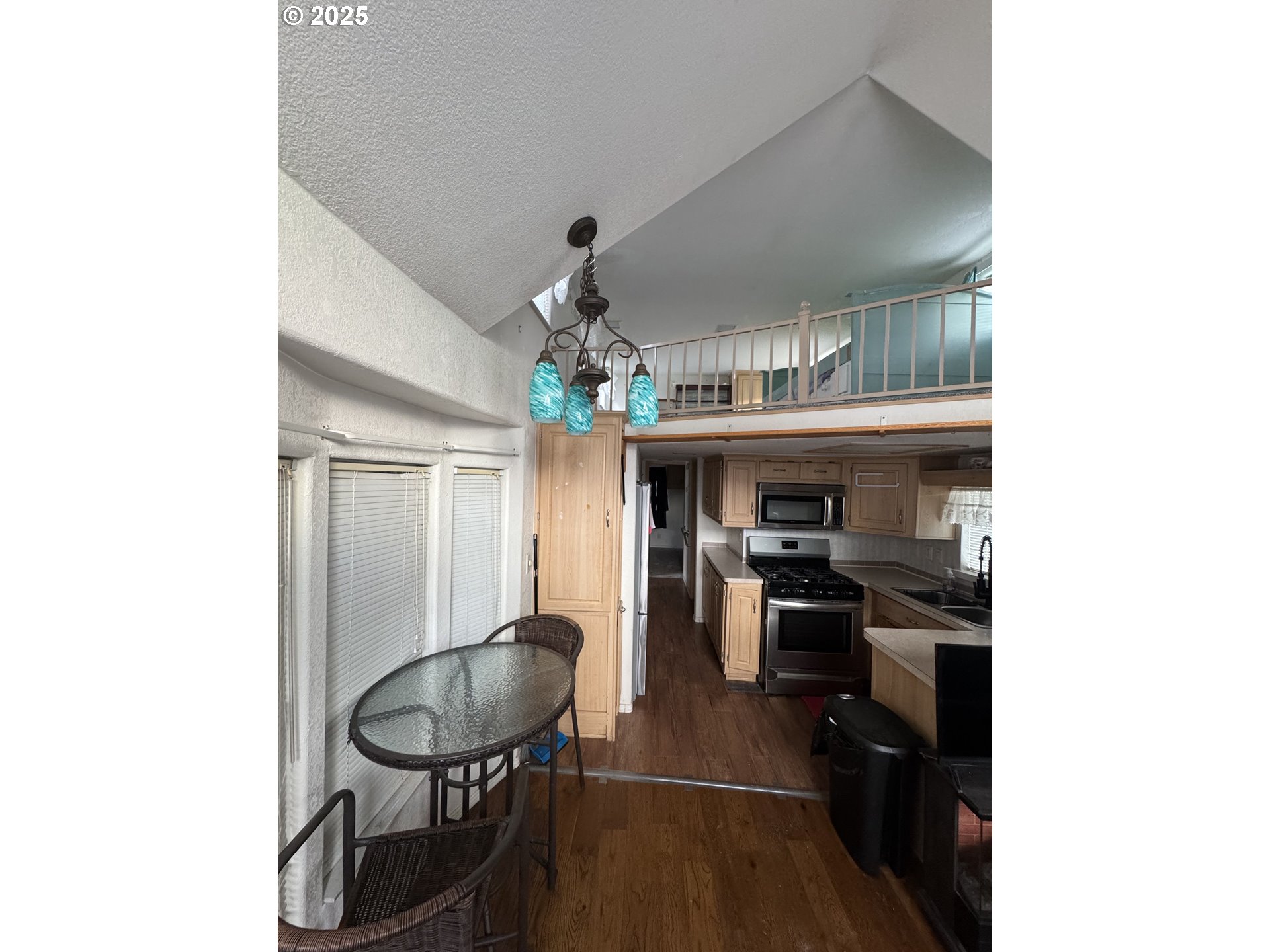 28800 Salmon River Highway Grand Ronde, OR 97347 - Photo 34 of 37 a kitchen with stainless steel appliances a dining table and chairs