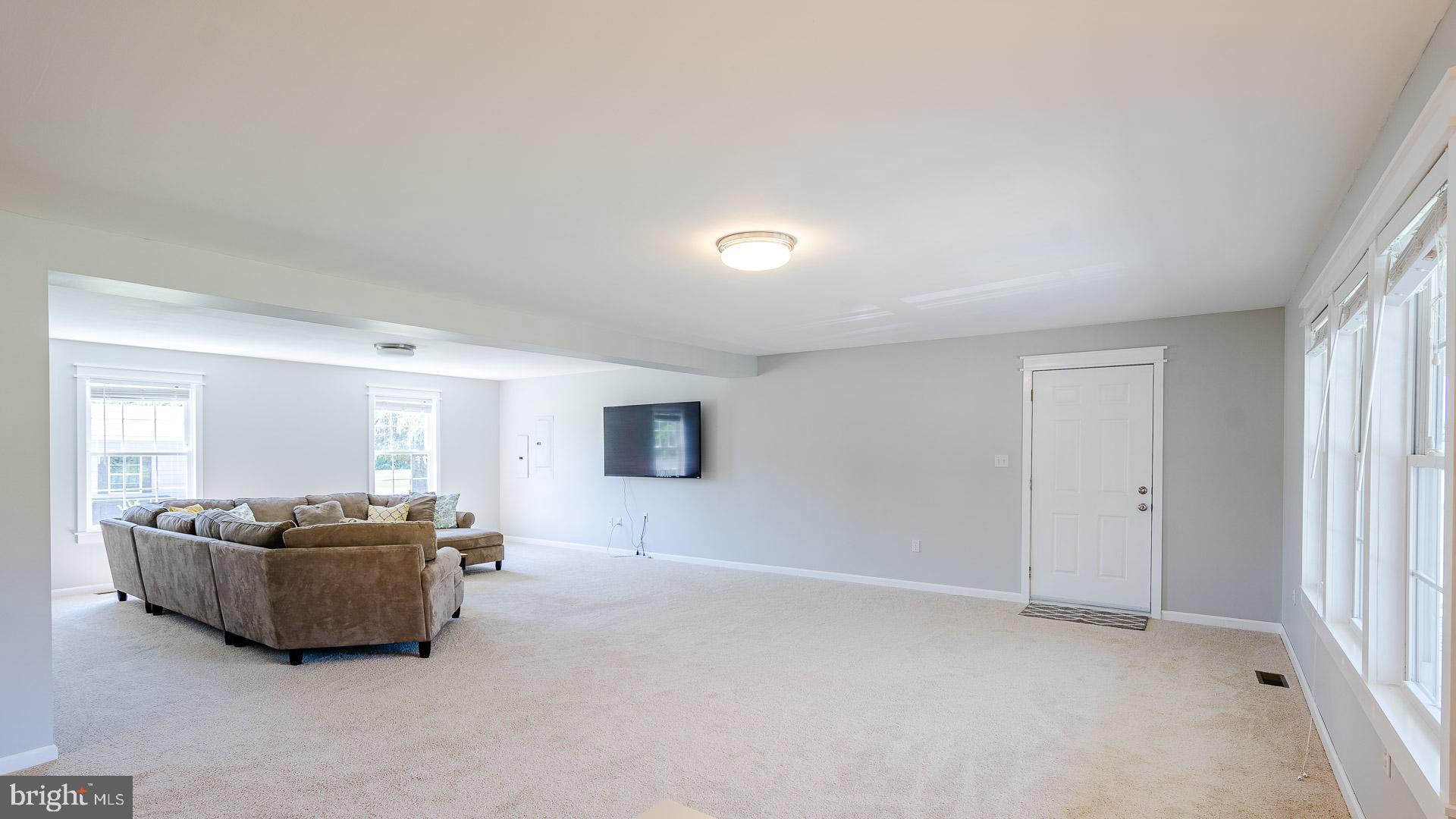 6825 Briscoe Turn Road Owings, MD 20736 - Photo 7 of 47 a living room with a couch and a cabinet