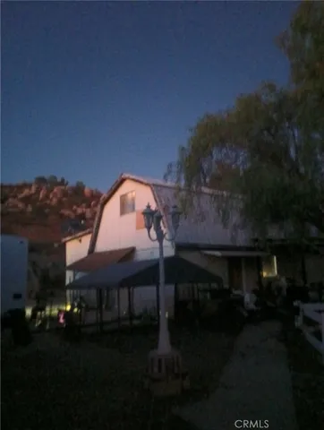 a view of house with outdoor space and garden