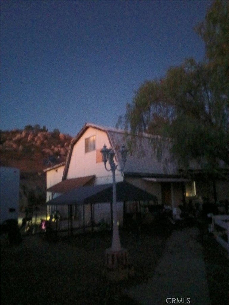 a view of house with outdoor space and garden